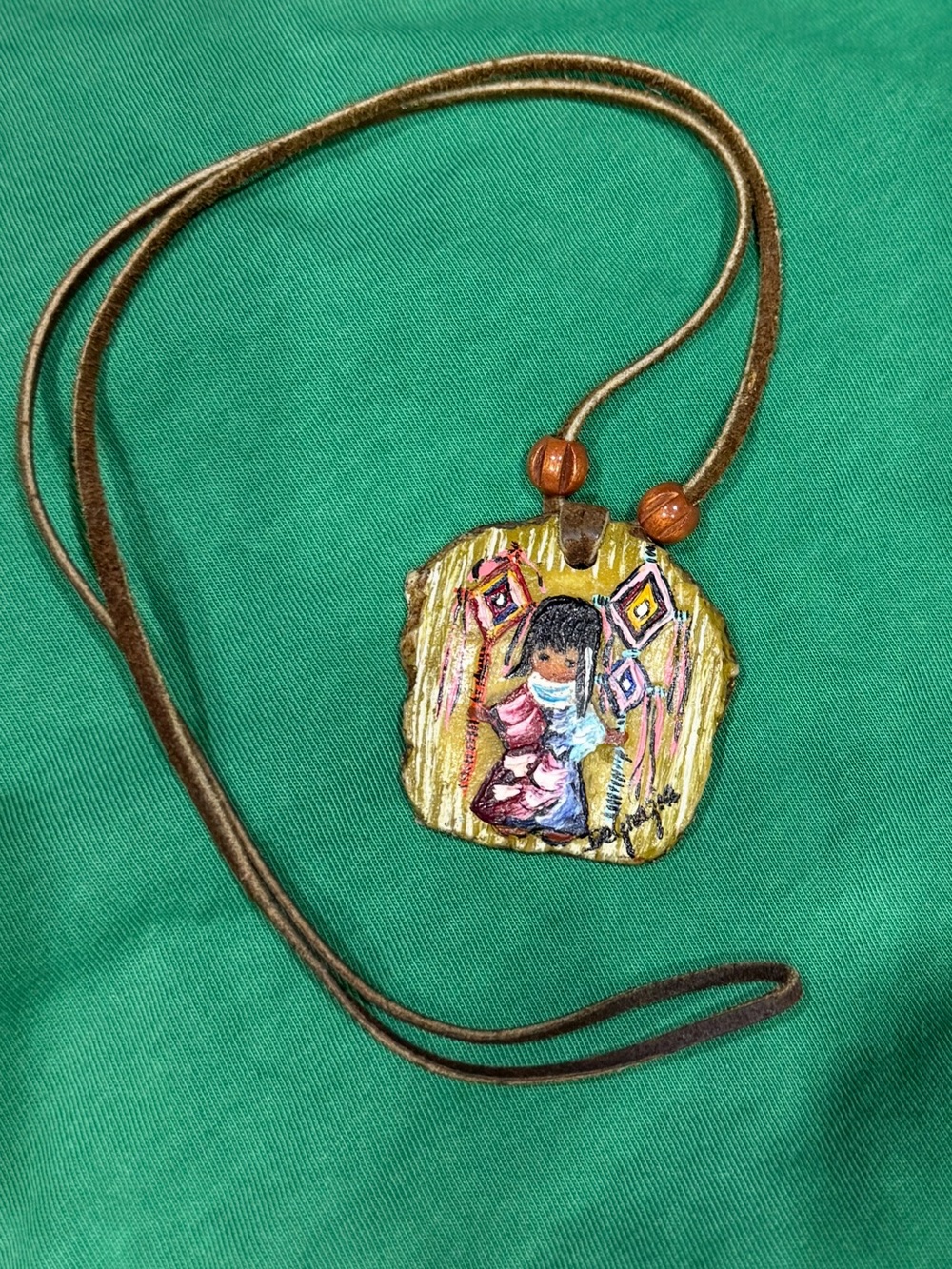 Ted Degrazia pendant of girl, collectable piece on leather cord. About 17”. Cute